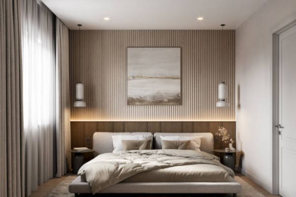 A modern bedroom with a low bed, wooden accent wall, abstract art, and warm lighting, creating a cozy and stylish atmosphere.